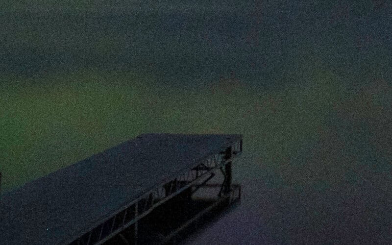 A dock in the water at night.
